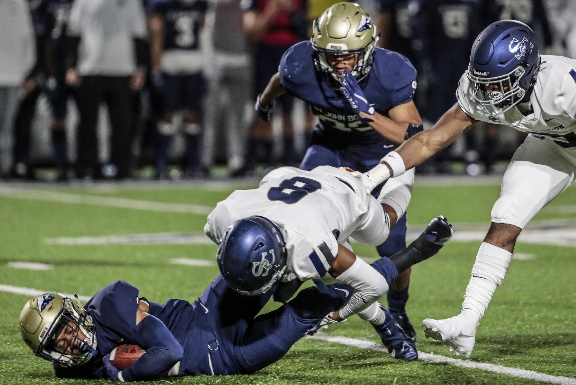 St. John Bosco kick returner Rayshon Luke is brought down by Sierra Canyon defensive back Elias Larry.