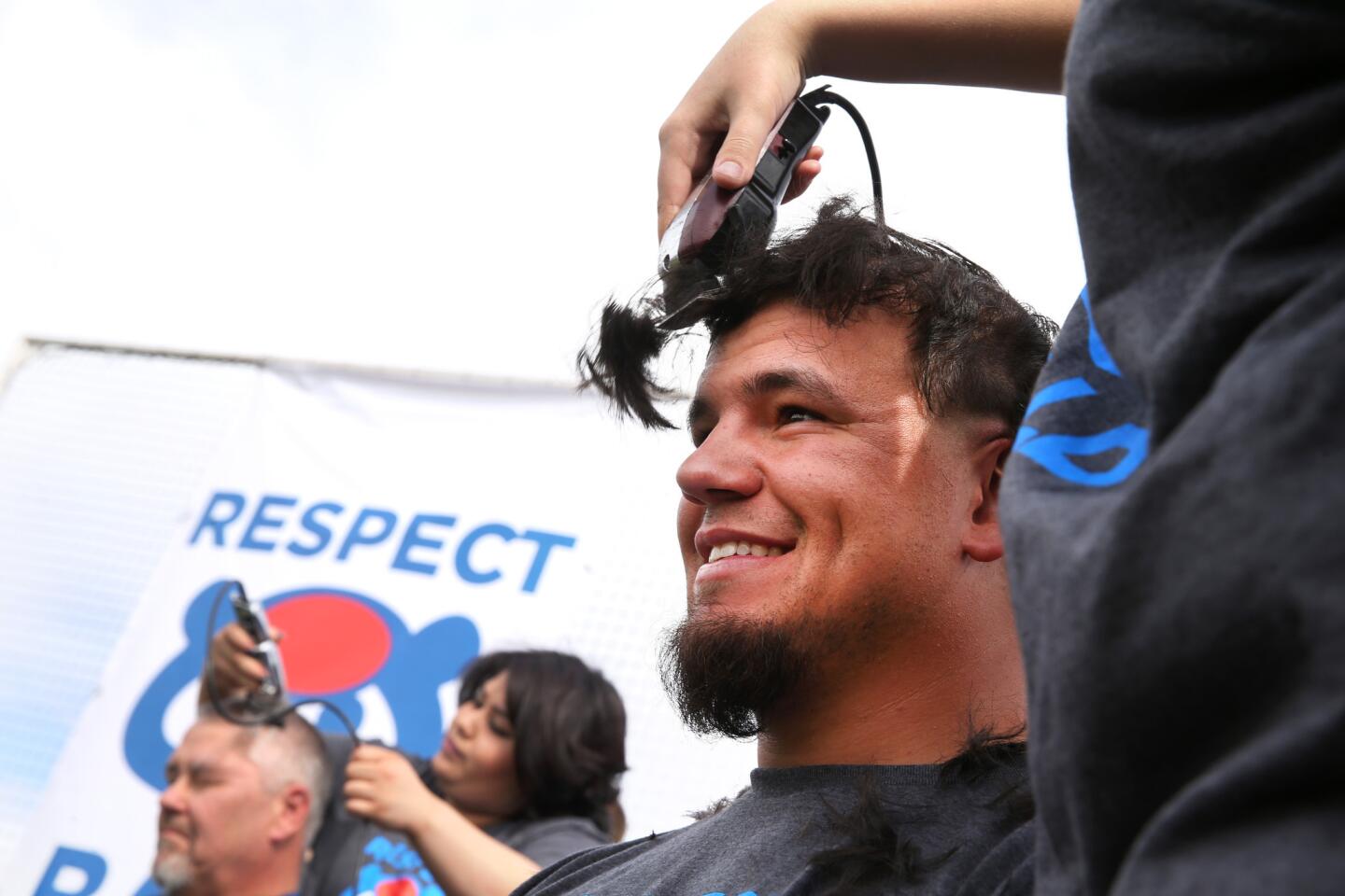 Cubs player Kyle Schwarber has his head shaved as he and other members of the organization participated in the Respect Bald Fundraiser prior to a preseason game at Sloan Park in Mesa, Ariz., on Saturday, March 5, 2016. Schwarber, manager Joe Maddon, Anthony Rizzo, and Ben Zobrist were among those who shaved their heads to benefit pediatric cancer research and support.