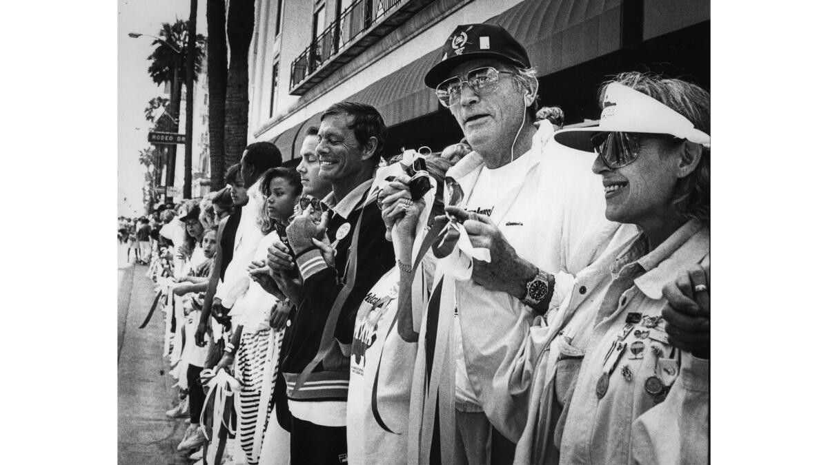 May 25, 1986: Actor Gregory Peck joins a Hands Across America line on Wilshire Boulevard in Beverly Hills.