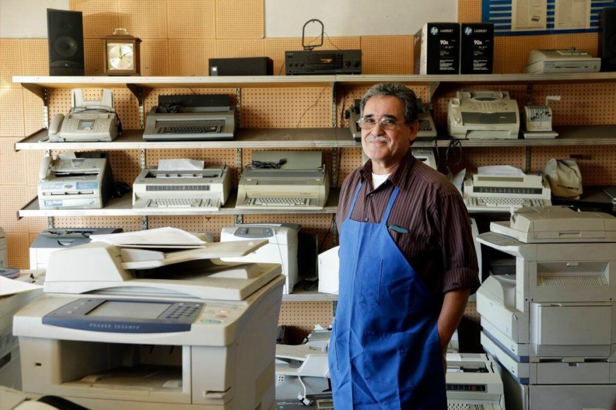Martin Quezada repairs typewriters at his International Office Machines shop in San Gabriel.