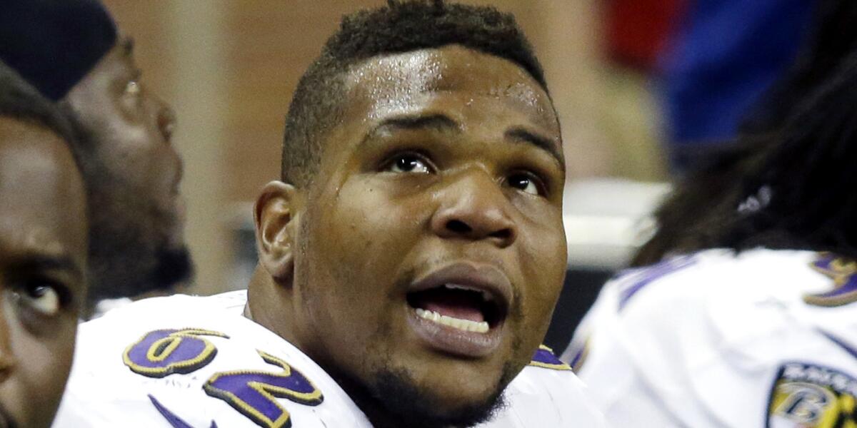 Baltimore Ravens nose tackle Terrence Cody checks the video screen at Ford Field during a game against the Detroit Lions.