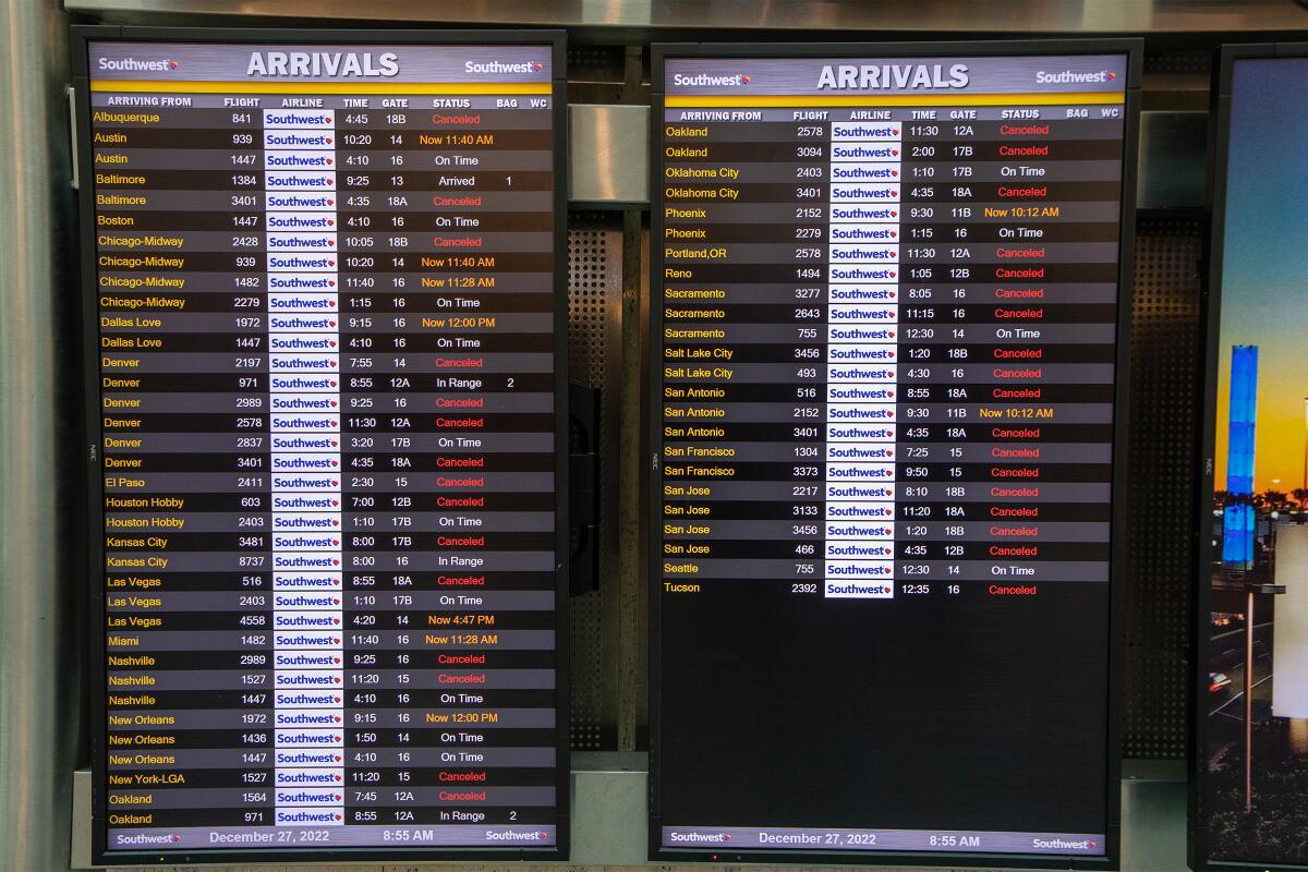 Southwest information boards show many canceled flights.