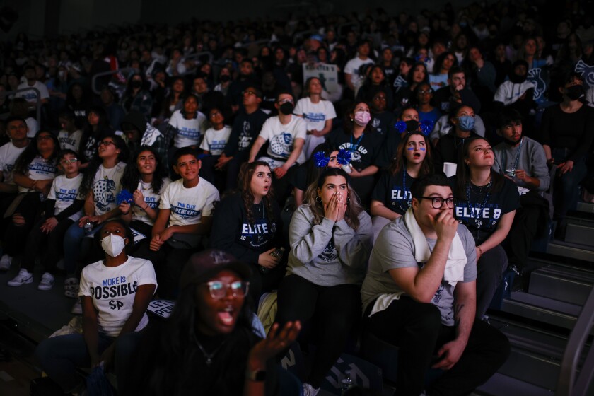 Saint Peter's fans react during a campus watch party Sunday.