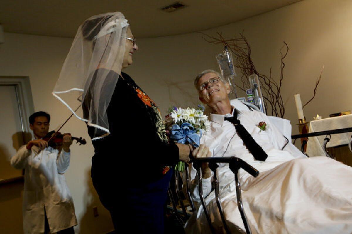 Cancer patient Dennis Lyman smiles as he marries longtime sweetheart Barbara Monds at the hospital.
