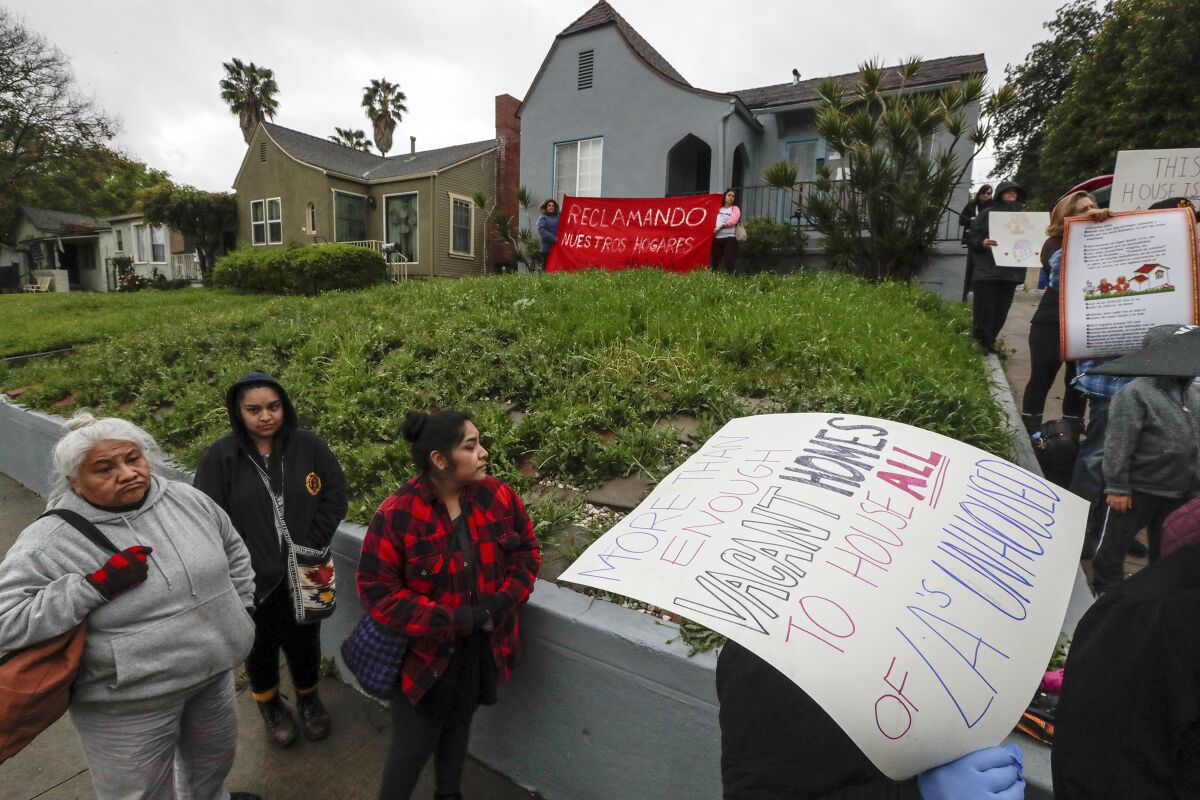 A group of homeless and housing insecure protesters and their supporters hold a rally on Sheffield Avenue on Saturday to "reclaim" a vacant home. 