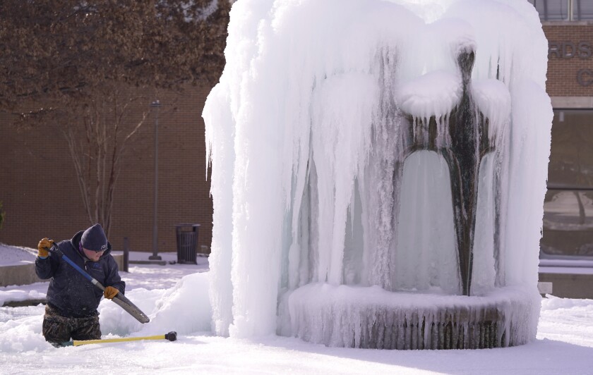 A man and an ice-covered fountain