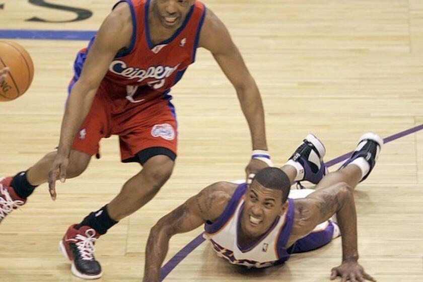 Clipper Sam Cassell gets called for a foul after knocking down Phoenix Suns Raja Bell while chasing a loose ball in Game 7 of the second round of the NBA Western Conference Playoffs at the US Airways Center in Phoenix, Monday.