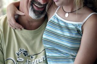 In a June 2003 photo, St. Paul Saints co-owner Mike Veeck poses with daughter Rebecca, 11, at his home in Charleston, S.C. The life of Rebecca Veeck, daughter of St. Paul Saints baseball team owner Mike Veeck, will be celebrated next month in Charleston, S.C. Rebecca died Sept. 30, 2019, in Charleston, after being diagnosed years ago with Batten disease, a rare genetic condition. She was 27. (Judy Griesedieck/Star Tribune via AP)