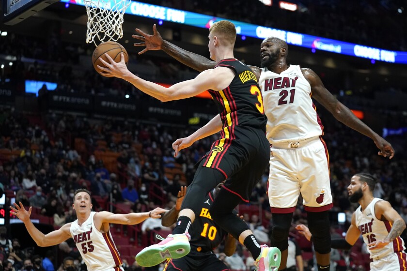 Atlanta Hawks guard Chris Clemons (3) looks to pass as Miami Heat center Dewayne Dedmon (21) defends during the first half of an NBA basketball game, Friday, Jan. 14, 2022, in Miami. (AP Photo/Lynne Sladky)