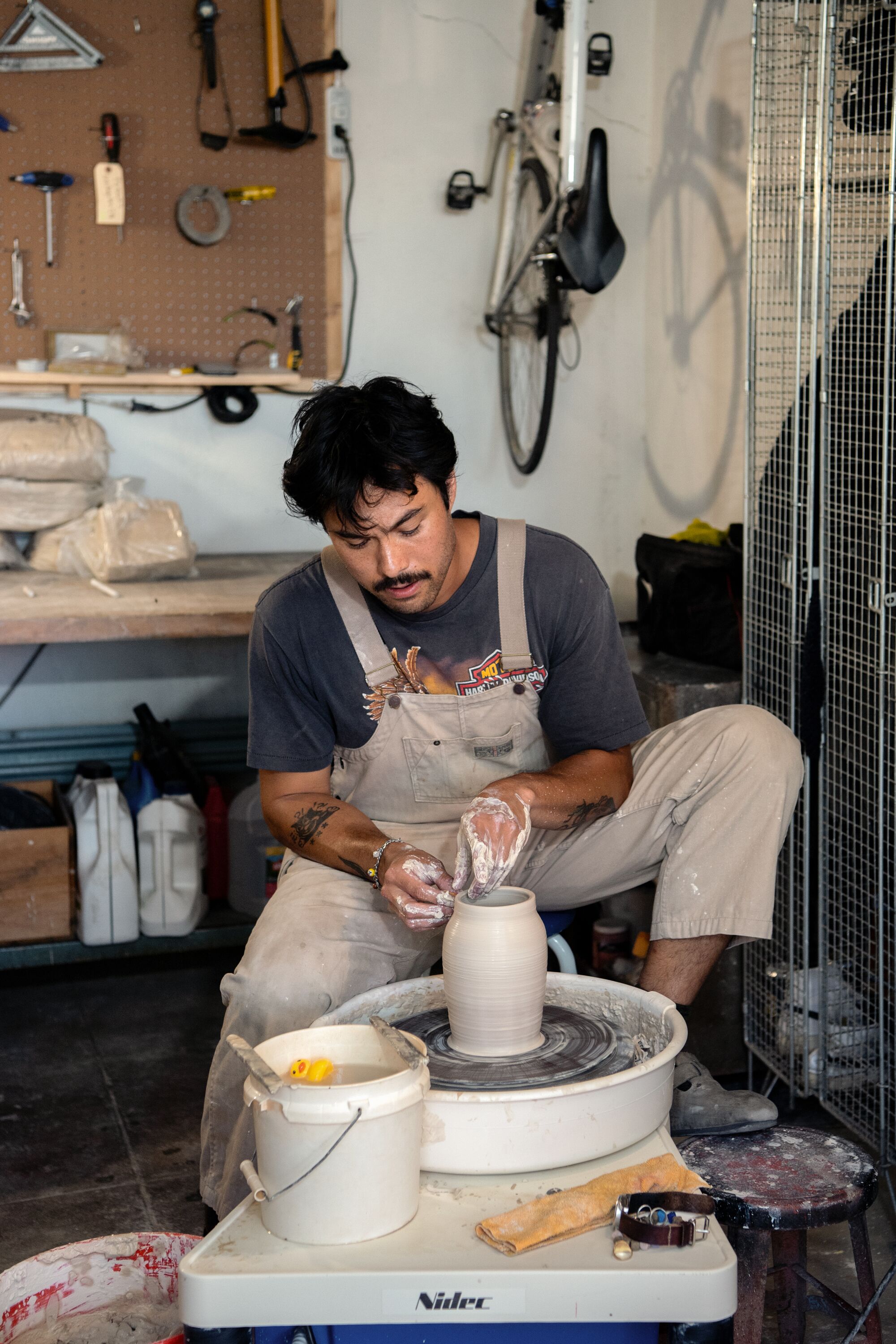 Daniel Dooreck throws a piece for photos inside his ceramics studio.