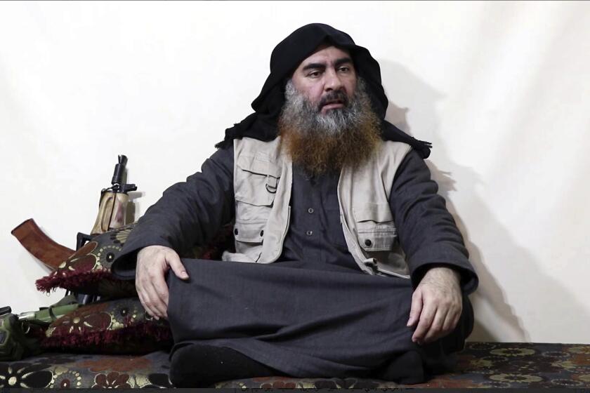 FILE - This file image made from video posted on a militant website April 29, 2019, purports to show the leader of the Islamic State group, Abu Bakr al-Baghdadi, being interviewed by his group's Al-Furqan media outlet. The IS erupted from the chaos of Syria and Iraq's conflicts and swiftly did what no Islamic militant group had done before, conquering a giant stretch of territory and declaring itself a "caliphate." U.S. officials said late Saturday, Oct. 26, 2019 that al-Baghdadi was the target of an American raid in Syria and may have died in an explosion. (Al-Furqan media via AP, File)