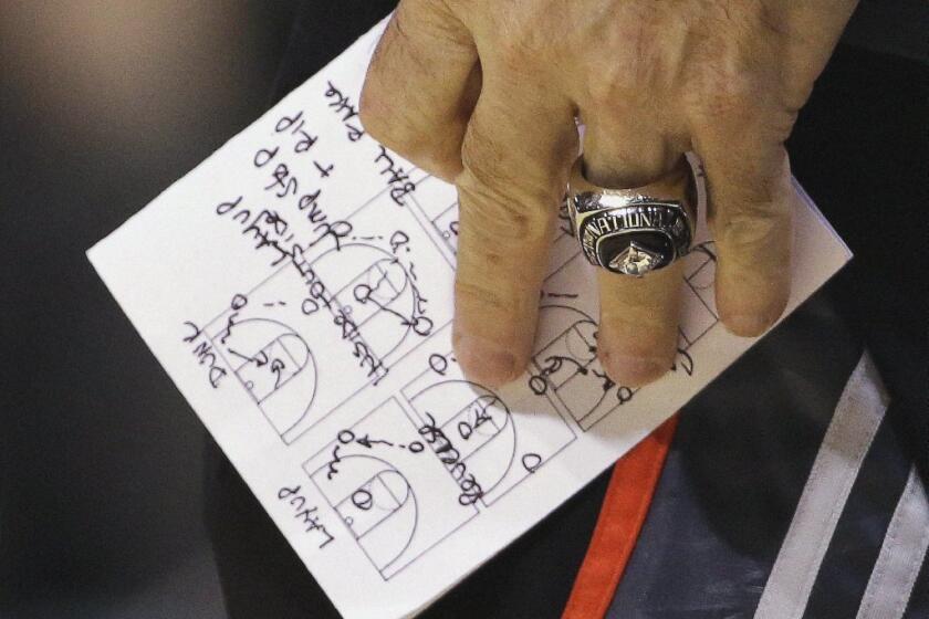 Louisville Coach Rick Pitino holds a diagram during practice Thursday.