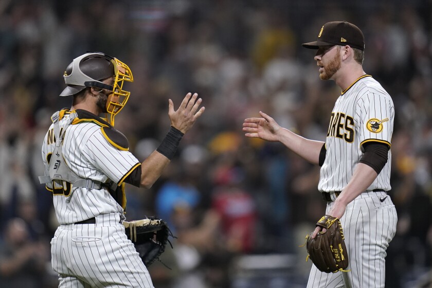 Padres pitcher Steven Wilson, right, celebrates with catcher Austin Nola 