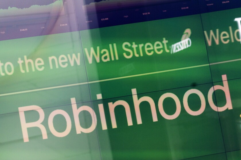 FILE - An electronic screen at Nasdaq displays Robinhood in New York's Times Square following the company's IPO, July 29, 2021. Growth keeps slowing for Robinhood Markets, the upstart company that upended the brokerage industry, and its stock keeps falling. The company whose easy-to-use trading app helped bring a new generation of investors to the market said Thursday, Jan. 27, 2022 that its revenue rose 14% in the fourth quarter from a year ago, less than half its growth rate in the summer months. (AP Photo/Mark Lennihan, File)