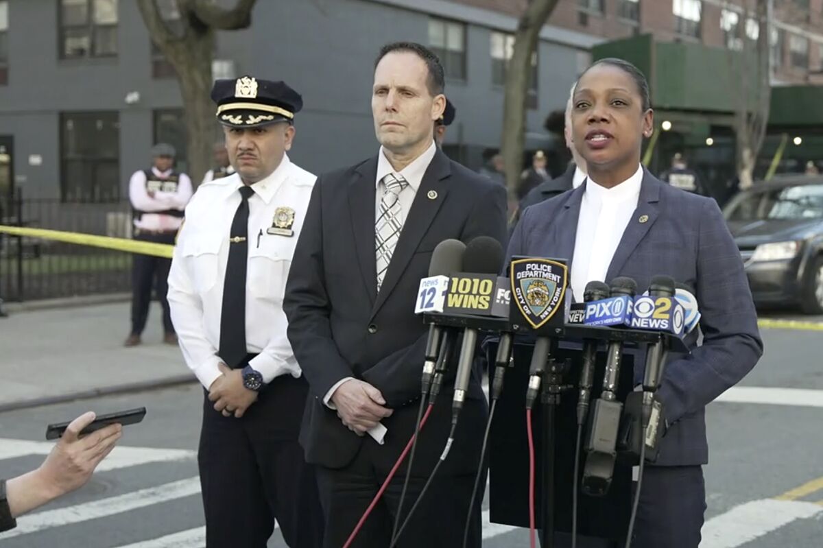 In this image taken from video provided by the NYPD, New York Police Commissioner Keechant Sewel, right, speaks during a news conference, Friday, April 8, 2022, in New York. A teenage girl has been killed and two other teens wounded in a shooting near a Bronx school. (NYPD via AP)