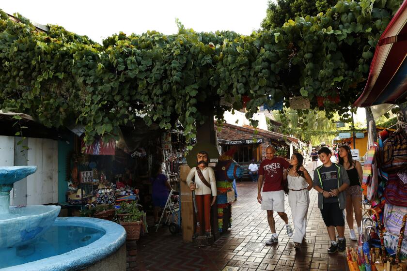 Visitors stroll along Olvera Street, part of downtown Los Angeles' El Pueblo de Los Angeles Historic Monument.