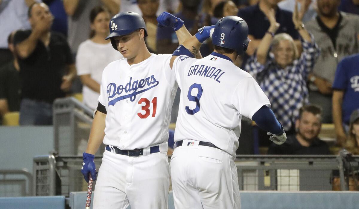 Dodgers' Yasmani Grandal, right, celebrates his home run with Joc Pederson during the seventh inning against the Tampa Bay Rays on Tuesday.