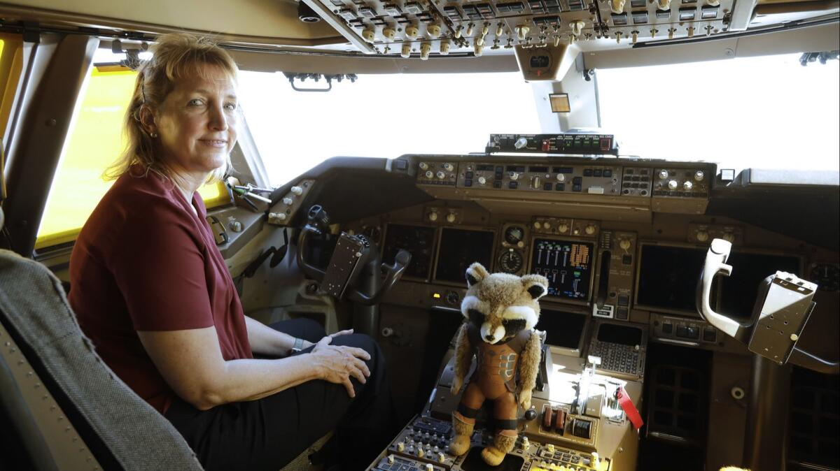 Kelly Latimer inside the cockpit of "Cosmic Girl." "Rocket" from "Guardians of the Galaxy" is the company's mascot as RACUN (pronounced raccoon) is an acronym for the Rocket Activation Control Unit.