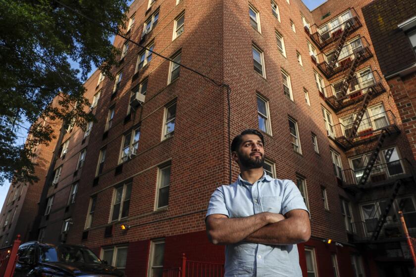 NEW YORK, NY - JUNE 12, 2019 ? Imran Rabbani, 21, stands in front of his old building, where his family of 7 used to live in one room apartment in Flushing neighborhood of New York City. Rabbani was 17 years old when he pleaded guilty to helping a friend plan an ISIS inspired terror plot to set off a pressure cooker bomb in NYC. During his 17 months in prison, Rabbani underwent a transformation. He became ?deradicalized? with the help of two prison guards who allowed him to check out books from the library and became passionate about law while taking college courses offered in prison by Essex County College. Now, two years after being released, Rabbani is wrapping up his first semester at NYU and is working as a manager at a halal burger joint. Like most young adults, Rabbani is still trying to figure out who he is, but his experience has fundamentally changed his outlook and relationship with his family, friends and religion. (Irfan Khan / Los Angeles Times)