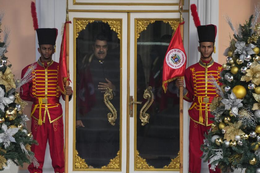 Venezuelan President Nicolas Maduro looks out a window as he waits for the arrival of Guinea-Bissau President Umaro Sissoco Embalo, at the Miraflores Presidential Palace, in Caracas, Venezuela, Wednesday, Nov. 2, 2022. (AP Photo/Ariana Cubillos)