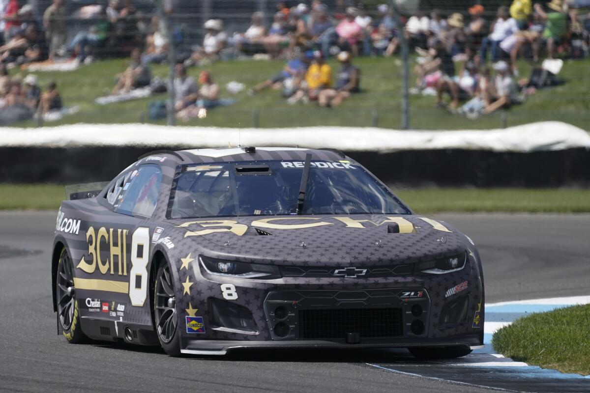Tyler Reddick drives into a turn during a NASCAR Cup Series auto race at Indianapolis Motor Speedway.