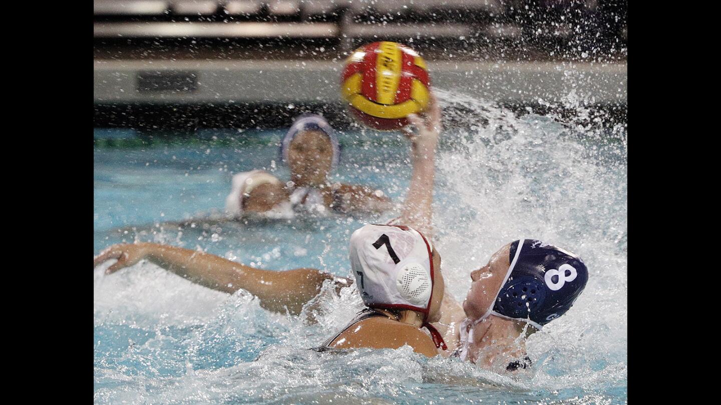 Crescenta Valley's Roxy Jackson-Gain shoots with aggressive defense by Burroughs' Bianca Sanchez in the Pacific League girls' water polo finals at Arcadia High School on Thursday, February 8, 2018.