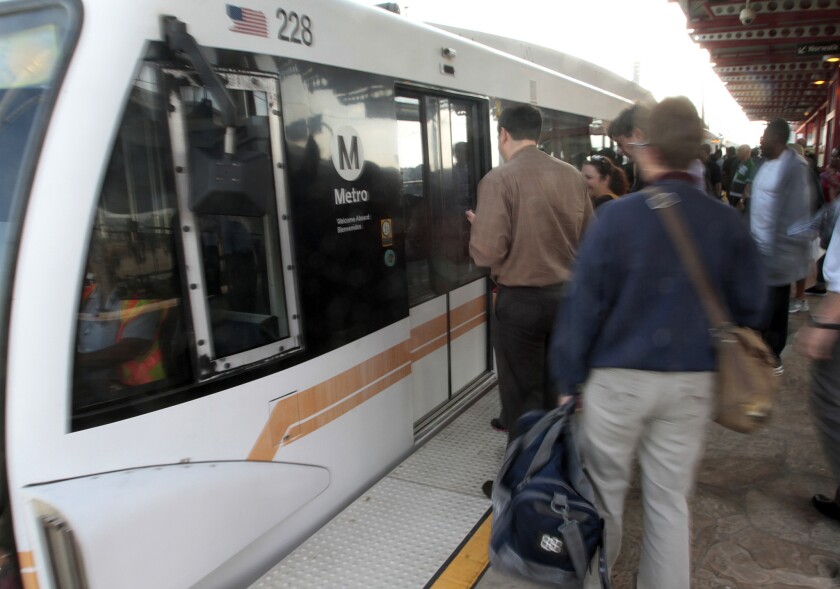 Passengers board a train at Metro Green Line's Aviation/LAX Station.