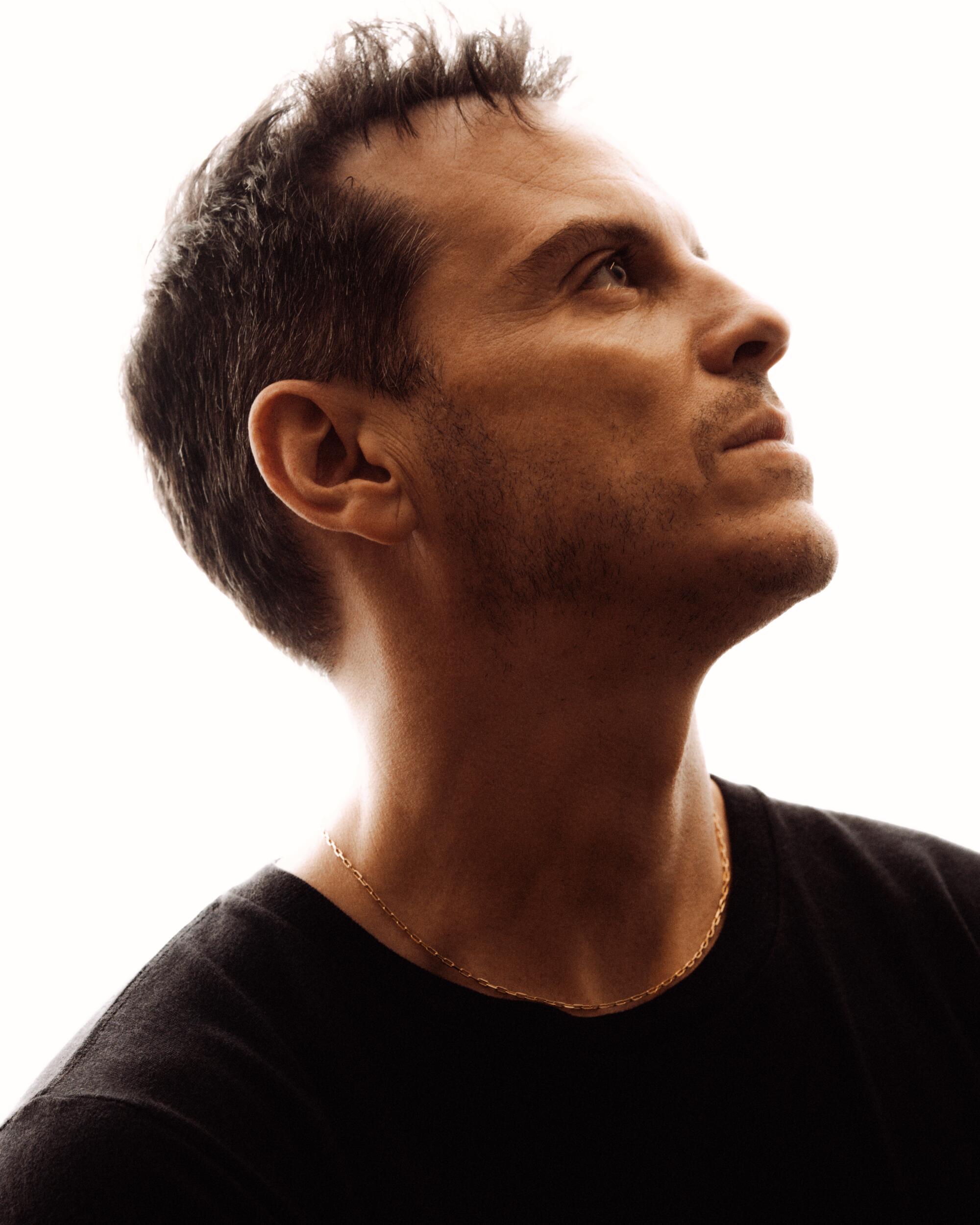 Andrew Scott looks up in a profile portrait.