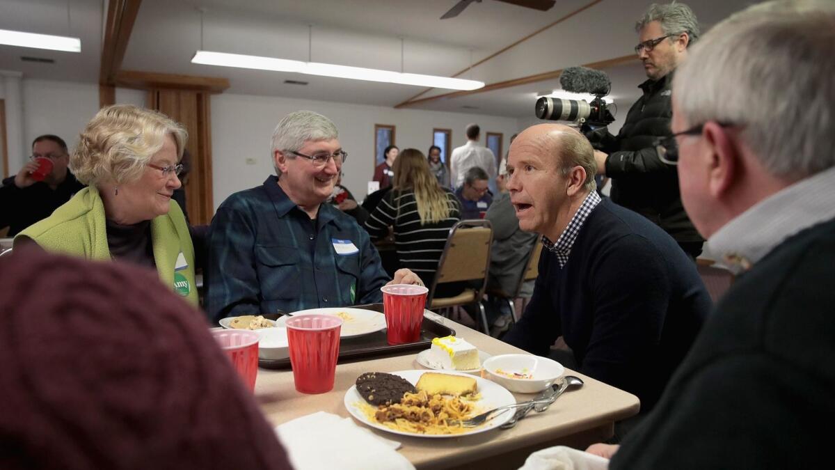Former Rep. John Delaney (D-Md.), middle right, speaks to guests at the Monroe County Democrats spaghetti supper last month at a church in in Albia, Iowa. Sen. Amy Klobuchar (D-Minn.) and Rep. Eric Swalwell (D-Dublin) also attended the event.