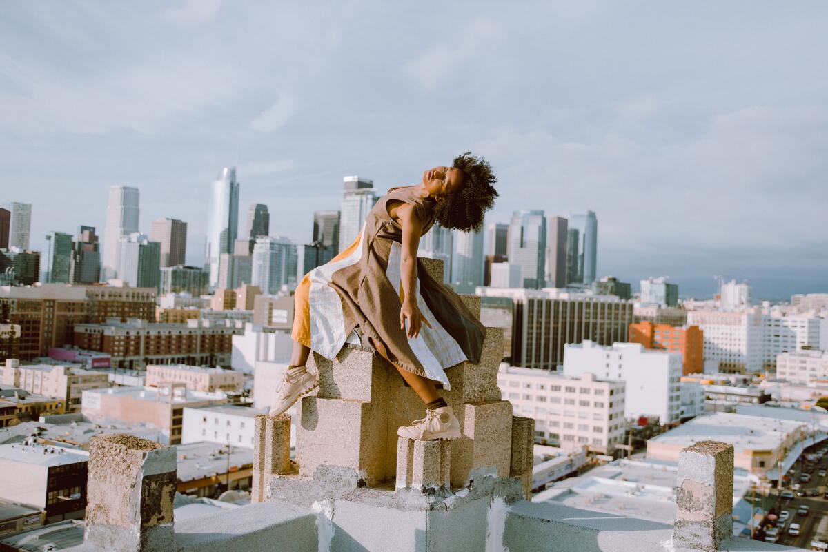 A dancer with the L.A.-based Heidi Duckler Dance appears to hover over downtown rooftops.