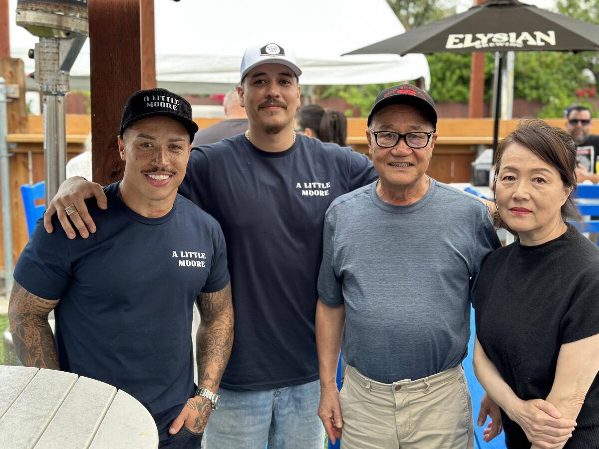 New owners Deon Dickey and Andy Vasquez with former Little Moore Cafe owners Chang and Misan Han.