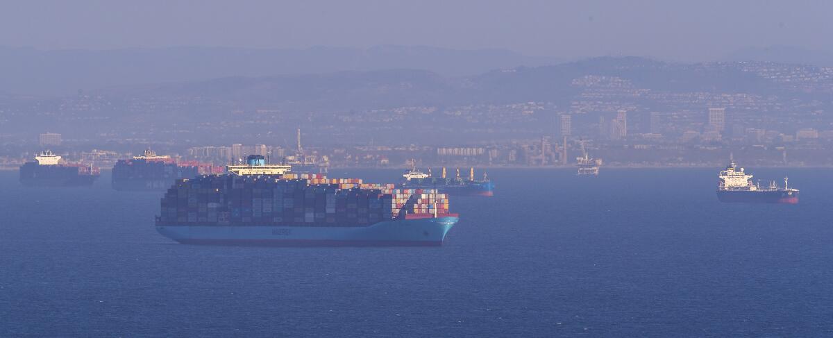 Dozens of container ships sit off the ports of Los Angeles and Long Beach, waiting to be unloaded.