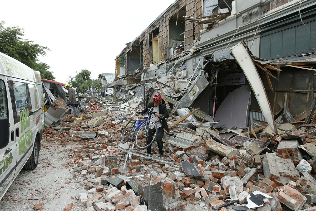 Brick walls collapse on a street in Christchurch, New Zealand during an earthquake in 2011. 