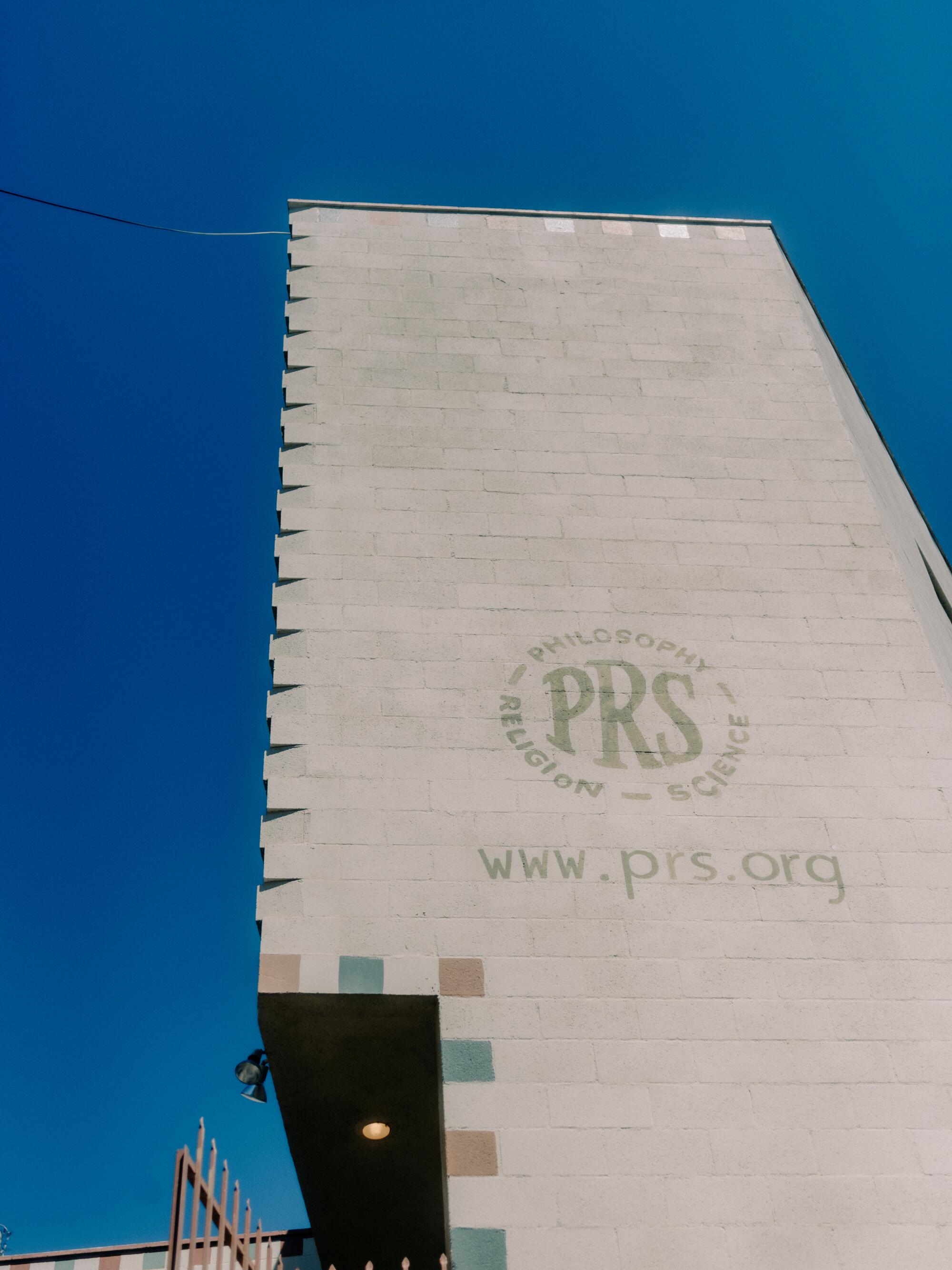 An exterior wall of the Philosophical Research Society reads "PRS" and "www.prs.org"