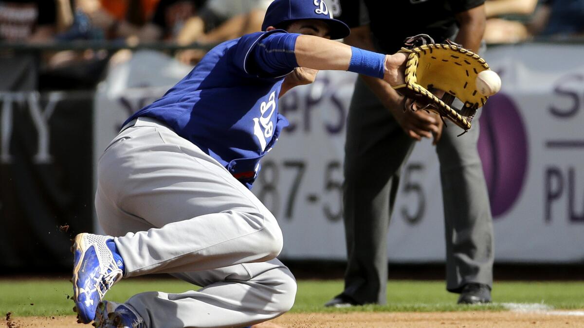 Dodgers first baseman Cody Bellinger fields a ball hit by San Francisco's Jarrett Parker during sixth inning Sunday.