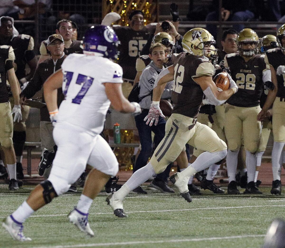 St. Francis' Tanner Tomko carries the ball after an interception against Cathedral in an Angelus League boys' football game at St. Francis High School on Friday, November 1, 2019. At halftime, St. Francis was leading 24-0.