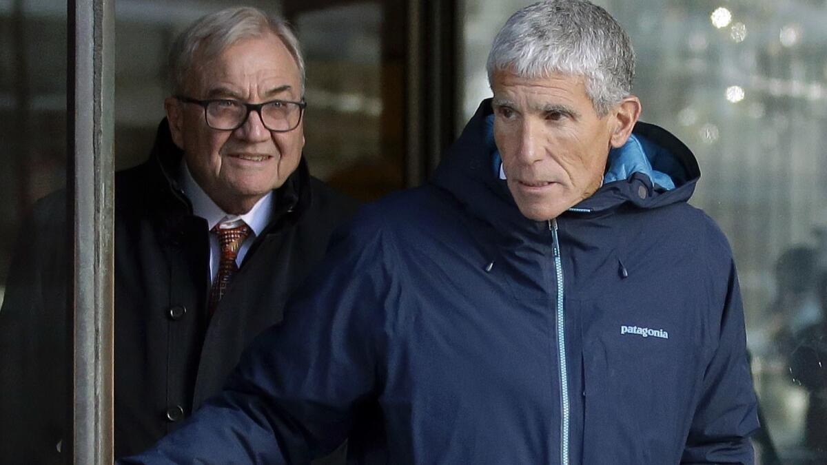 William "Rick" Singer, front, exits federal court in Boston after he pleaded guilty on March 12 to charges in a nationwide college admissions bribery scandal.