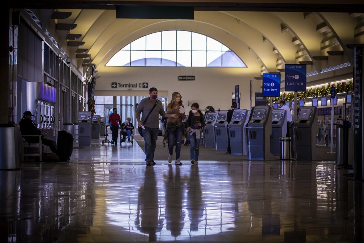 Travelers make their way to their gate at John Wayne Airport. 