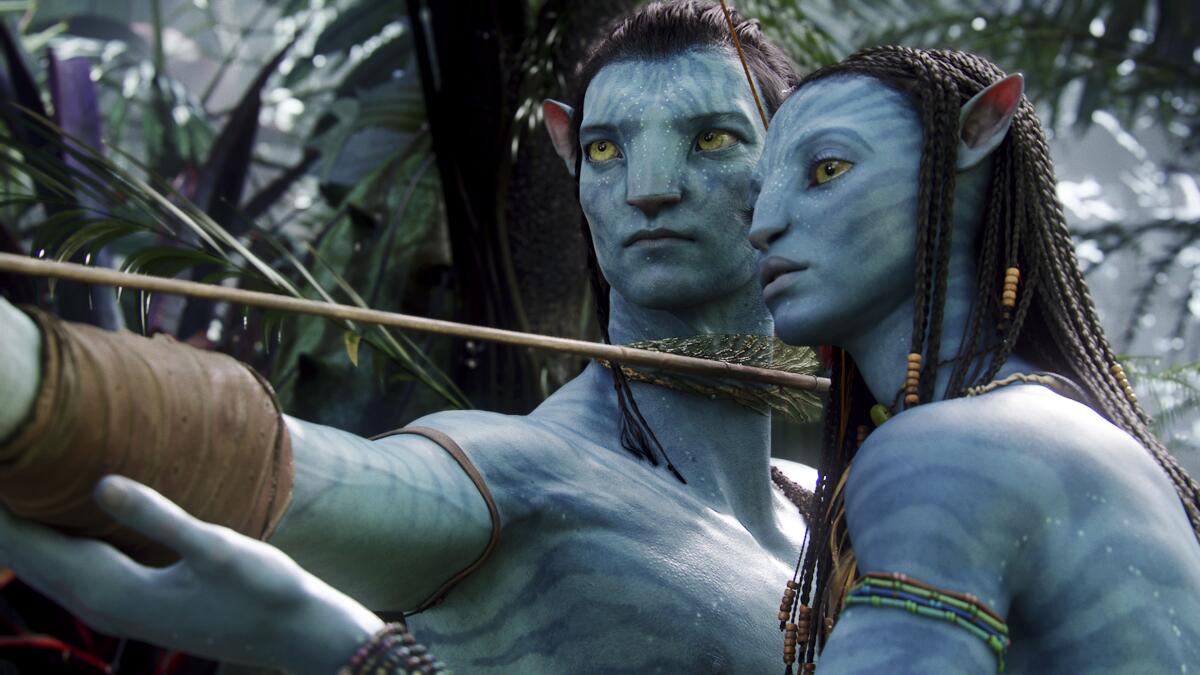 A blue male human-like creature and a female human-like creatures stand in front of each other.