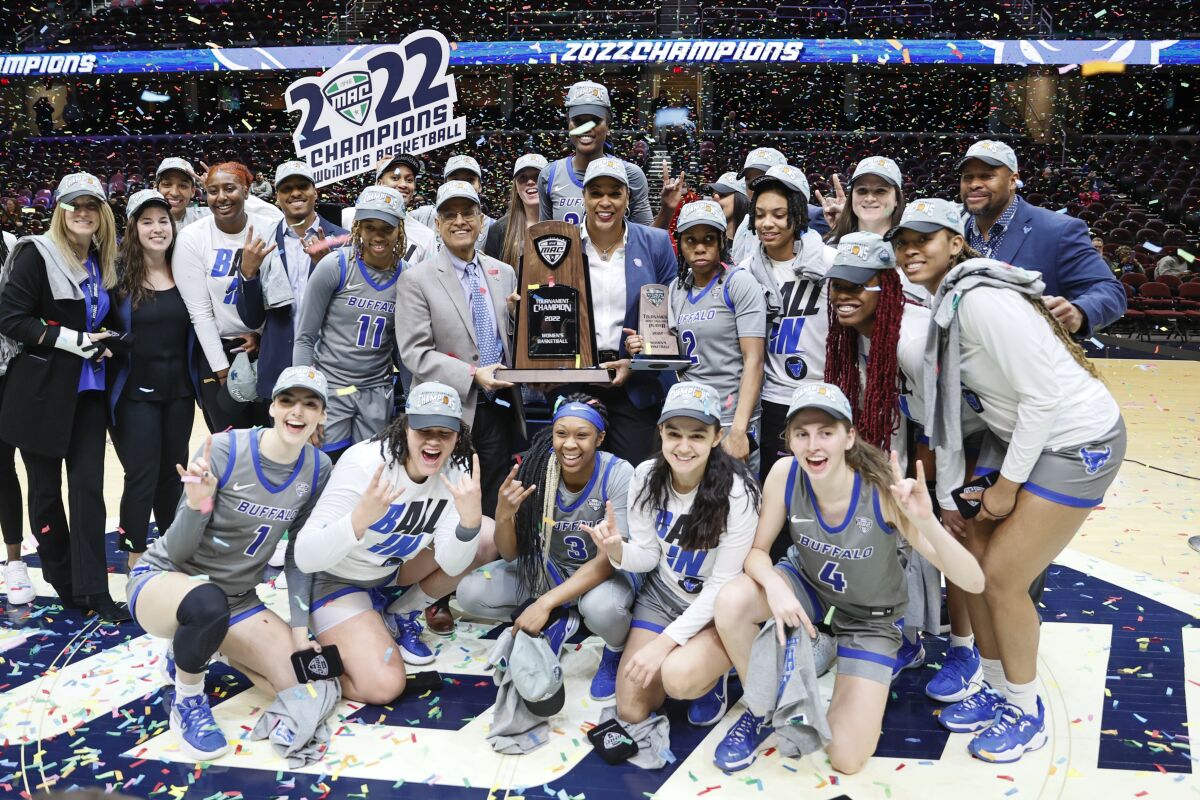 The Buffalo Bulls celebrate a 79-75 win against Ball State in an NCAA college basketball game for the championship of the Mid-American Conference women's tournament, Saturday, March 12, 2022, in Cleveland. (AP Photo/Ron Schwane)