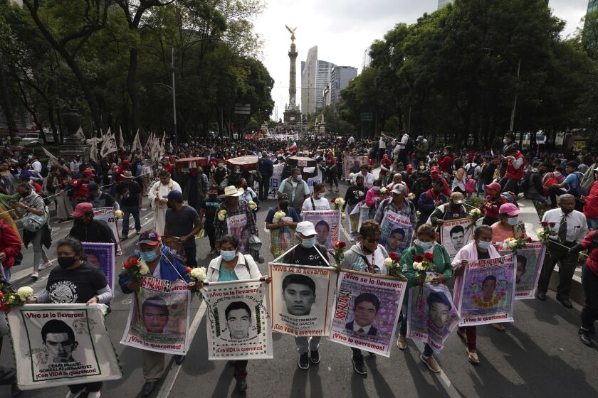 FILE - Relatives and classmates of the missing 43 Ayotzinapa college students march in Mexico City, Sept. 26, 2022, marking the anniversary of their disappearance. Experts investigating the disappearance of 43 students from Ayotzinapa in 2014 denounce in a new case report released Friday, March 31, 2023, that the Mexican army has offered false information, has moved documentation to avoid tracking it, and hides evidence about the case. (AP Photo/Marco Ugarte, File)