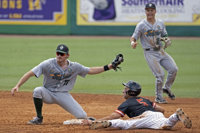Tulane shortstop Gavin Schulz (2) looks on as Tulane second baseman Brady Hebert (17) holds up the ball after tagging out Sam Houston State's Justin Wishkoski (5) during an NCAA college baseball tournament regional game Saturday, June 3, 2023, in Baton Rouge, La. (Hilary Scheinuk/The Advocate via AP)