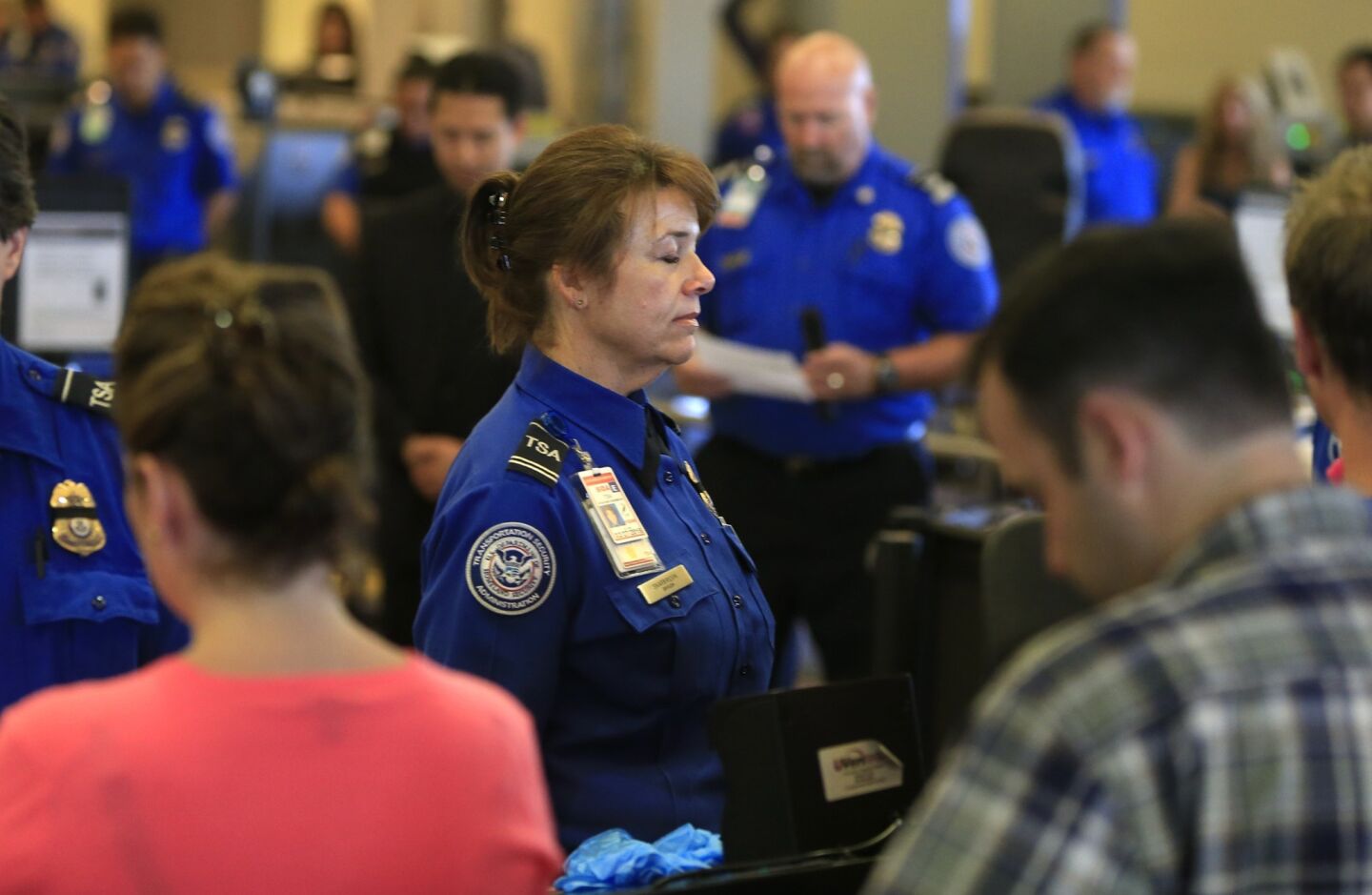 Transportation Security Administration employees observe a moment of silence on Friday at 9:20 a.m., the same time of last Friday's shooting that left TSA Officer Gerardo Hernandez dead.