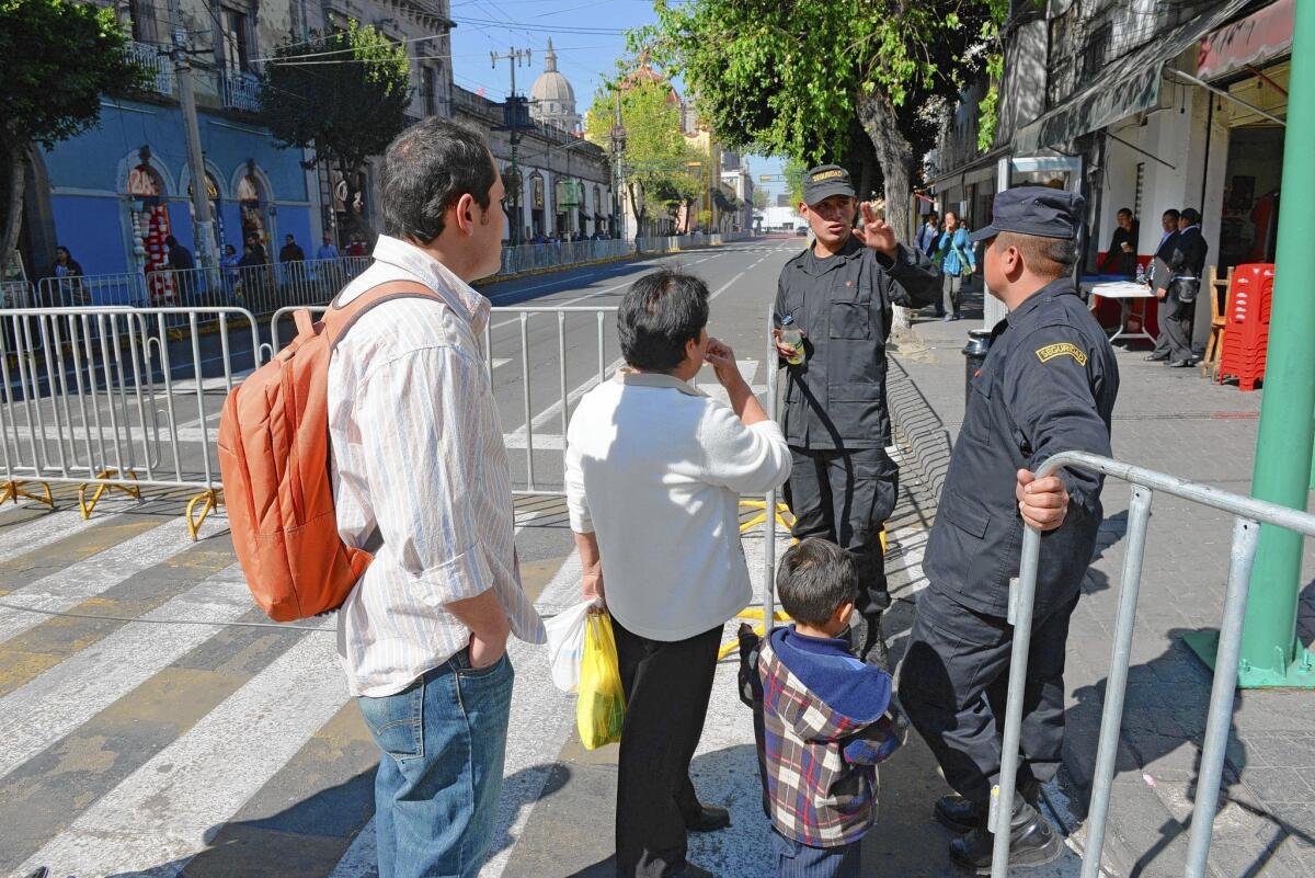 Presidential guards block a street in Toluca, Mexico, where President Obama and Canadian Prime Minister Stephen Harper will meet with Mexico's leader.