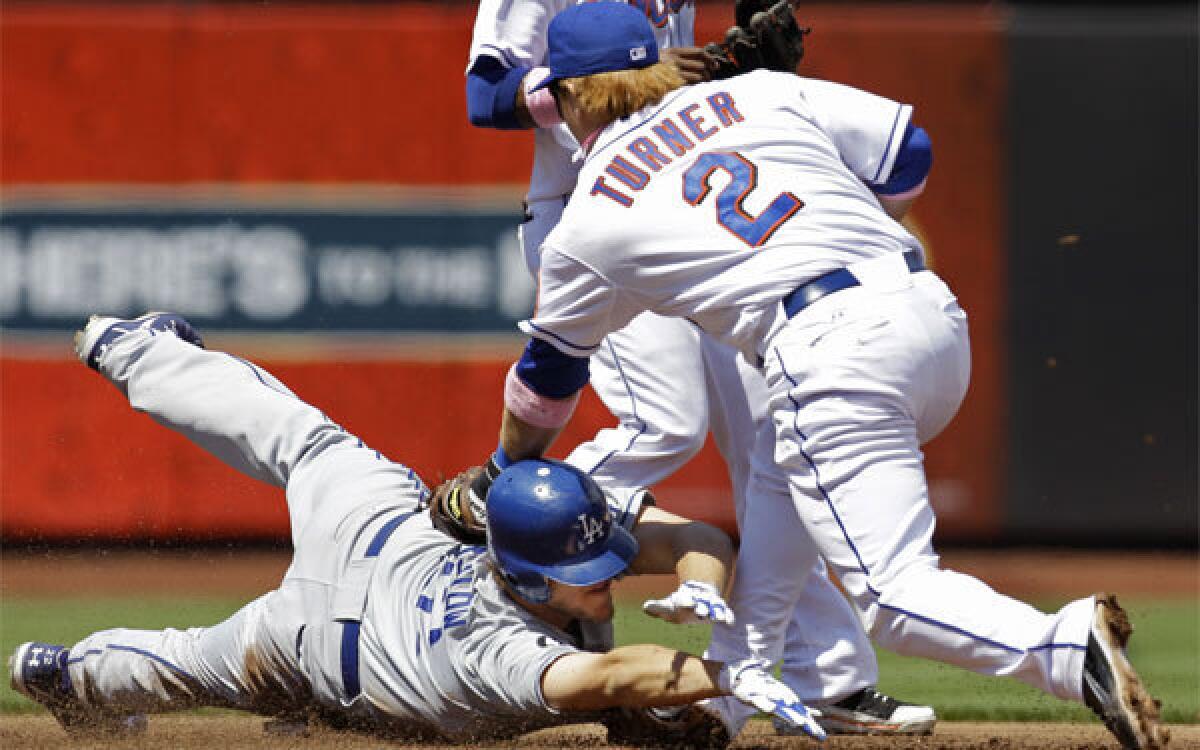 New York Mets second baseman Justin Turner tries to tag Dodgers pitcher Clayton Kershaw during a game in 2011. On Wednesday the Dodgers signed Turner to a minor-league contract with an invitation to spring training.