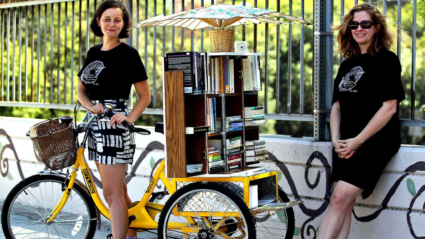 The Feminist Library on Wheels is the creation of Jenn Witte, left, and Dawn Finley. They plan to take their mobile lending library of feminist texts all around Los Angeles.