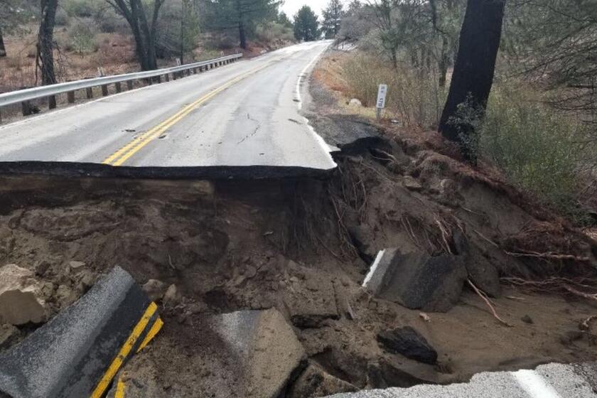FILE - This Feb. 15, 2019, file photo, released by Caltrans District 8 shows storm damage to the San Jacinto Mountains Highway 243 near Idyllwild, Calif. The scenic highway leading to the Southern California mountain resort of Idyllwild will remain closed for months as crews repair substantial damage caused by winter and spring storms. Officials say it could stay closed until next year. (Caltrans District 8 via AP, File)