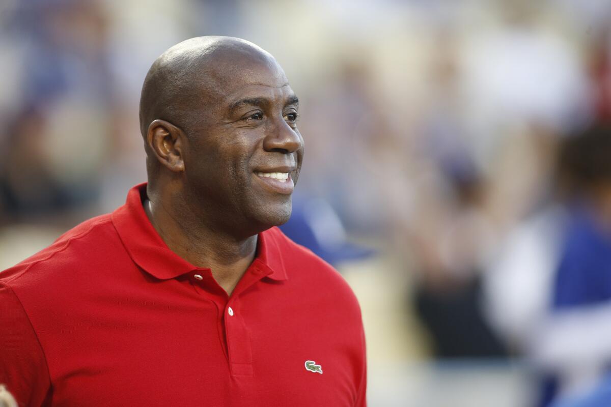 Magic Johnson, shown watching the Dodgers on April 28, had plenty of high praise for the Clippers following their Game 6 victory over San Antonio on Thursday night.