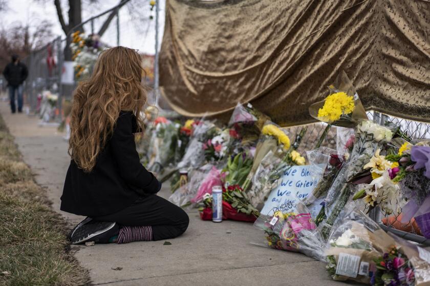 BOULDER, CO - MARCH 22: A mourner visits the location where a gunman opened fire at a King Sooper's grocery store on Monday on March 23, 2021 in Boulder, Colorado. Ten people were killed in the attack. (Photo by Chet Strange/Getty Images)