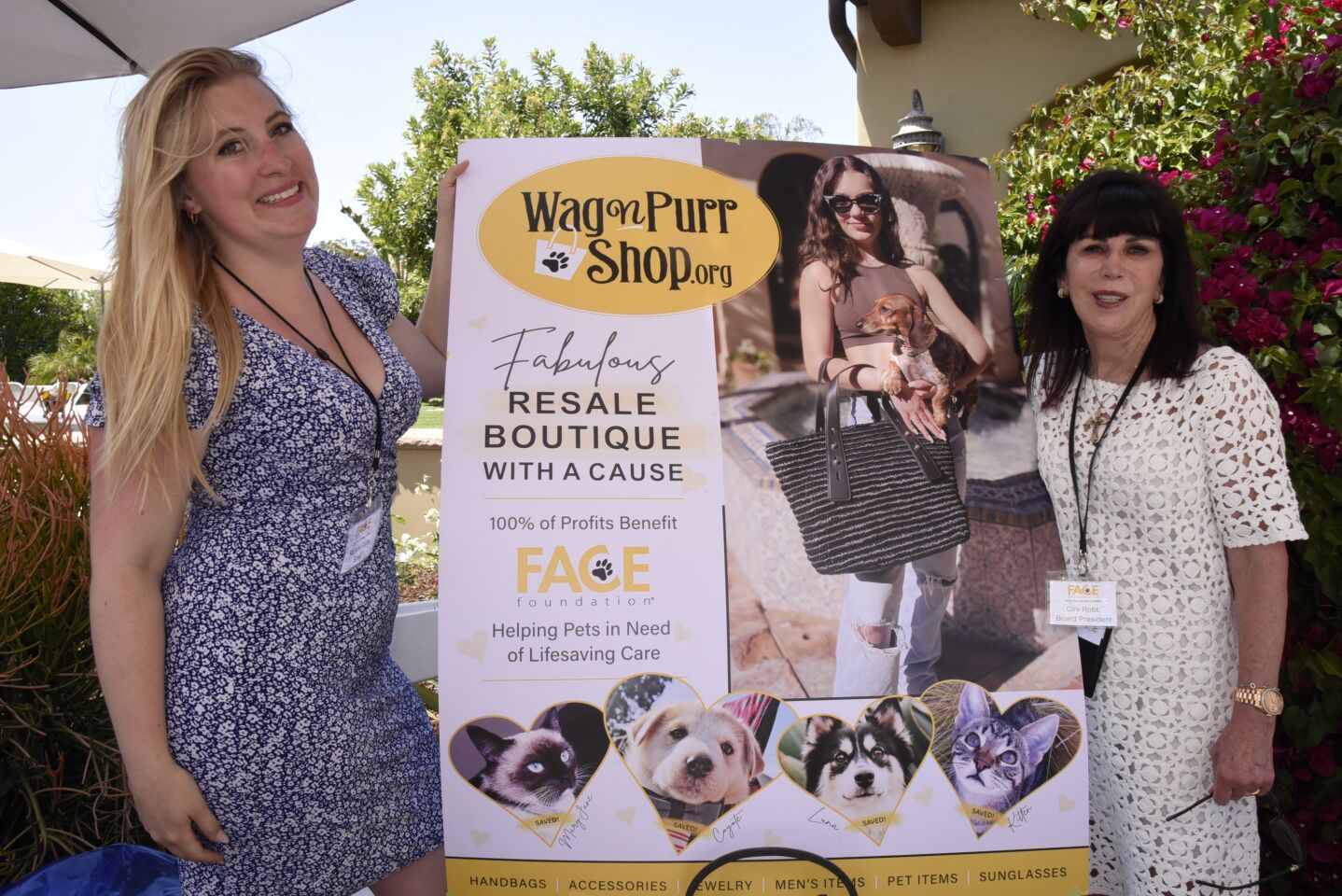 Marketing Director Nichole Gray, FACE Foundation Board President/Founder Cini Robb with sign promoting FF online shop (Wagnpurrshop.org)